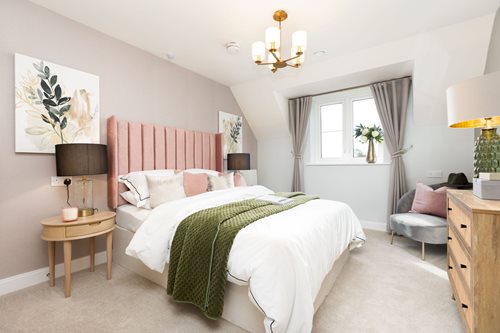 a bedroom with a bed and lamps