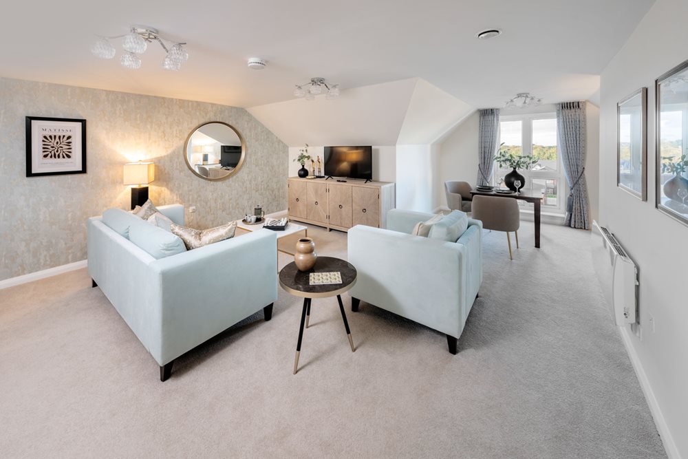 a large living room with a white couch and a round table
