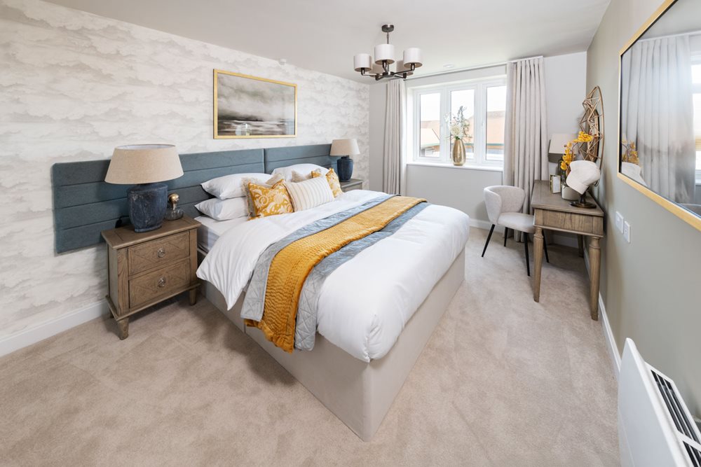 a bedroom with a bed and a desk