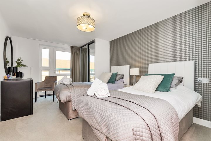a bedroom with a bed and a chair