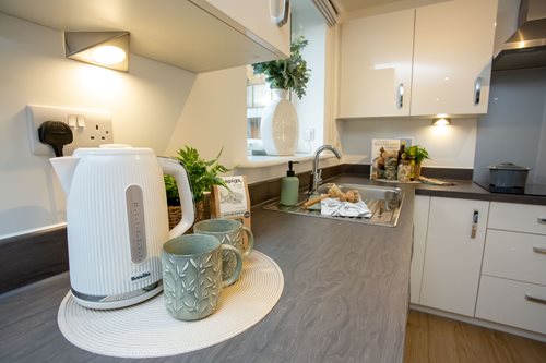 a kitchen with a coffee maker and a coffee pot