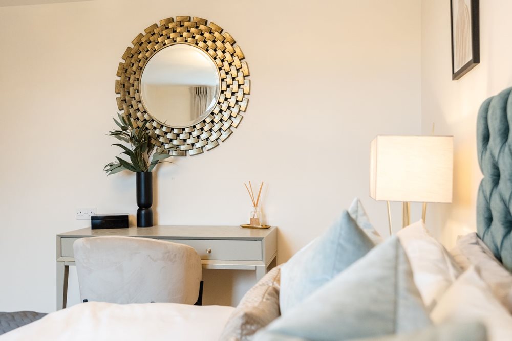 a mirror above a bed