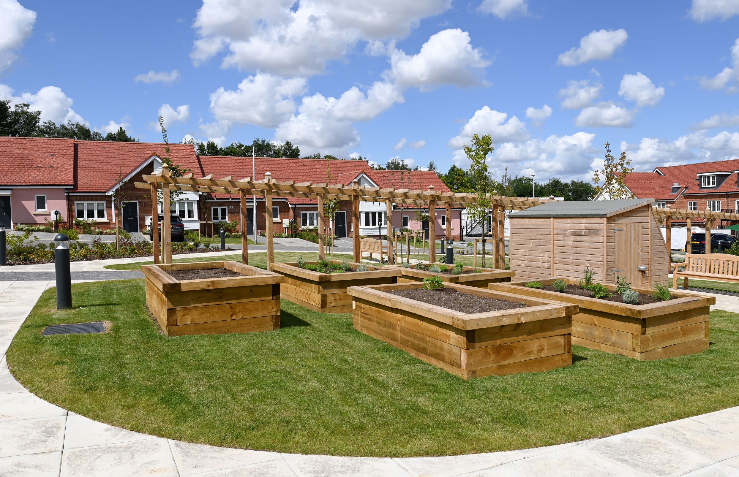 a yard with a bench and a building in the background