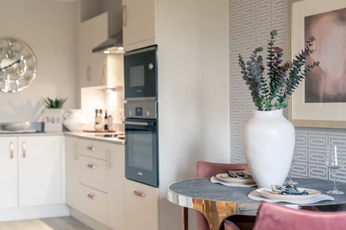a kitchen with a table and chairs