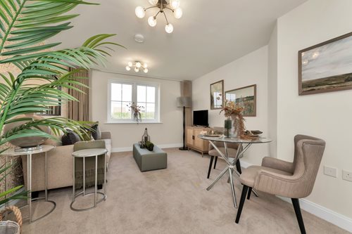 a living room with a table and chairs