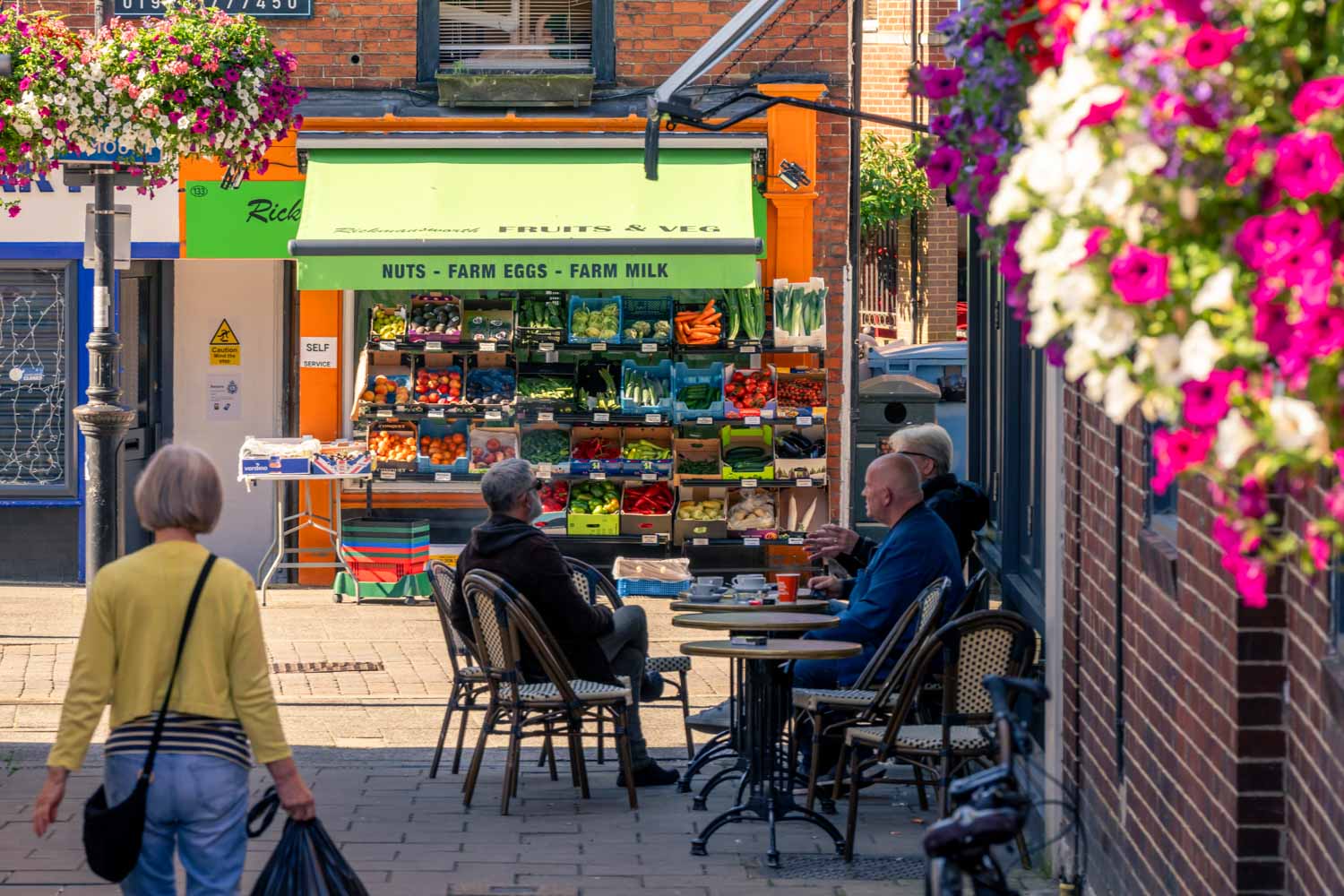 a group of people sitting at a table outside a restaurant