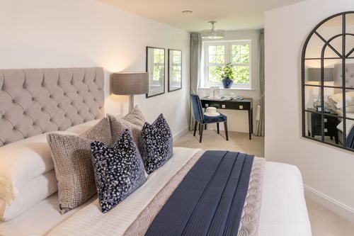 a bedroom with a bed and a desk