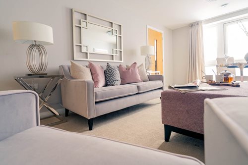 a living room with a couch and a lamp