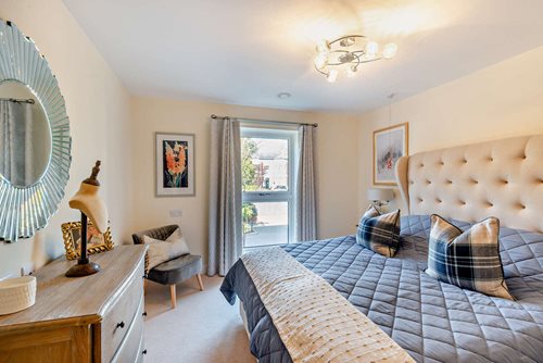 a bedroom with a bed and a chair