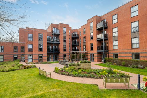 a building with a garden in front