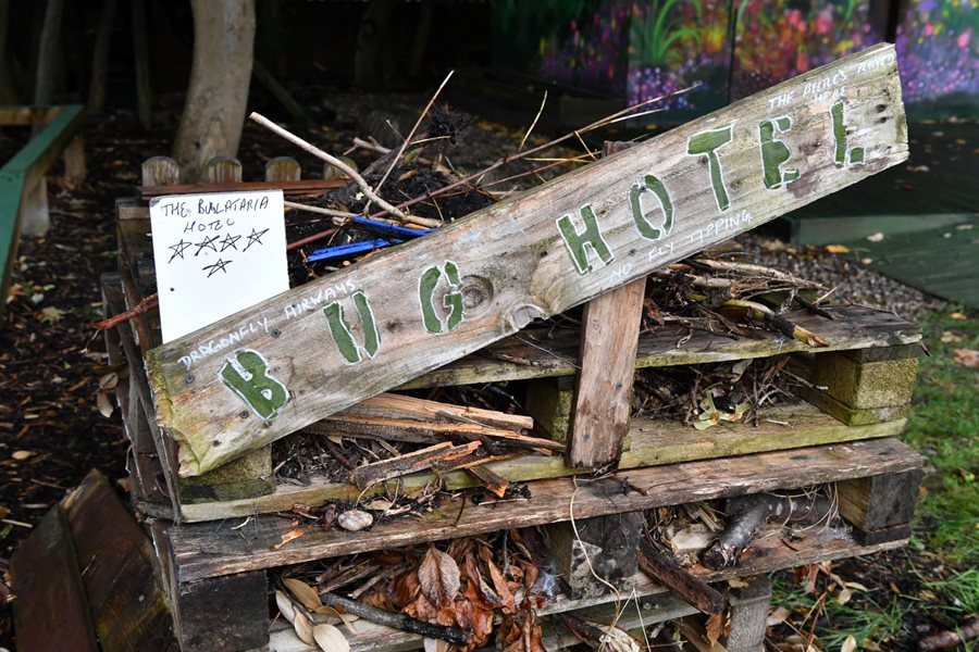 a wooden bench with a sign on it