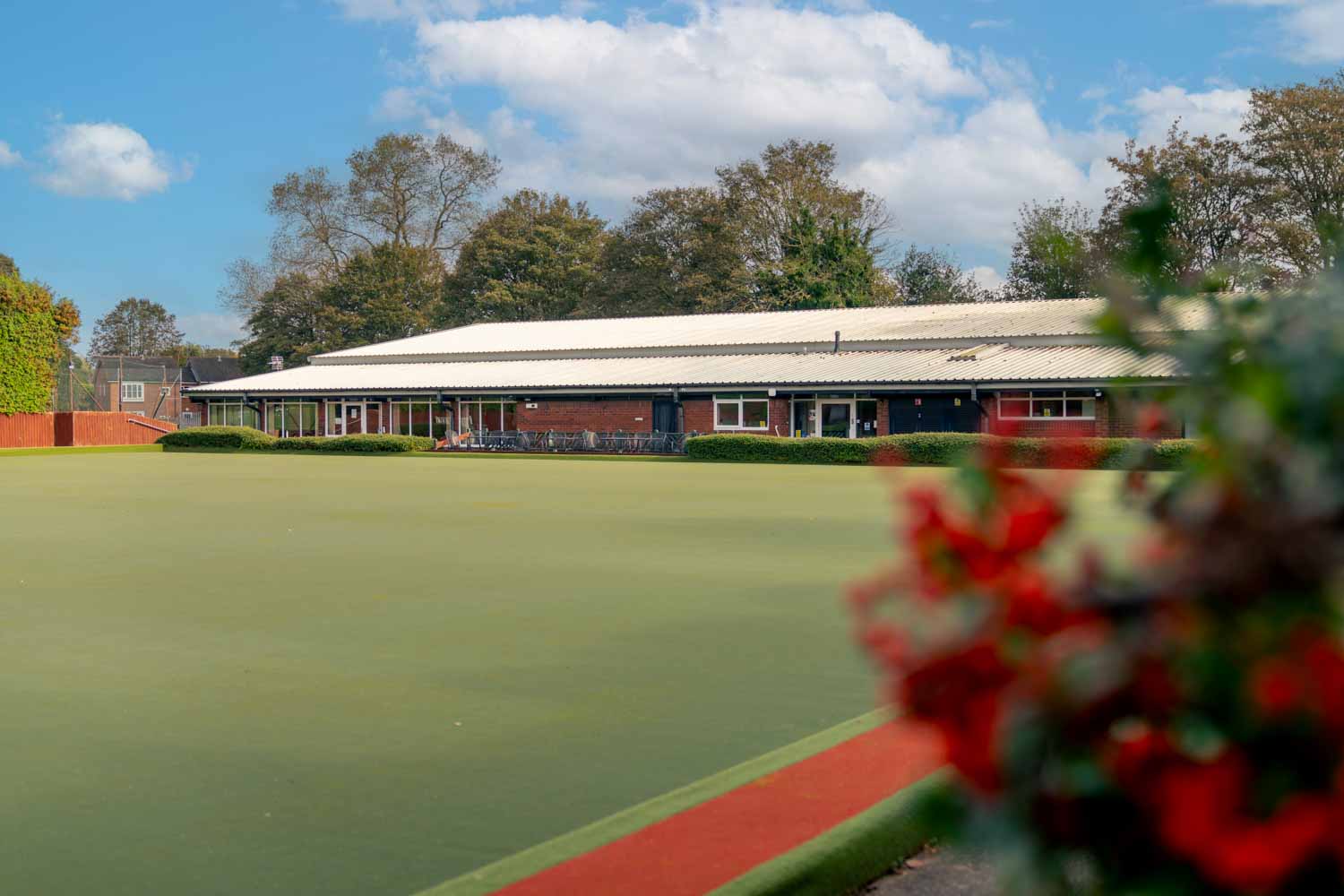 a large building with a green lawn
