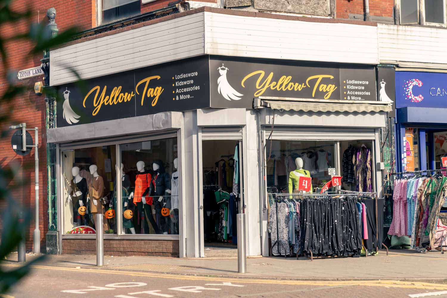 a store front with clothes on the window