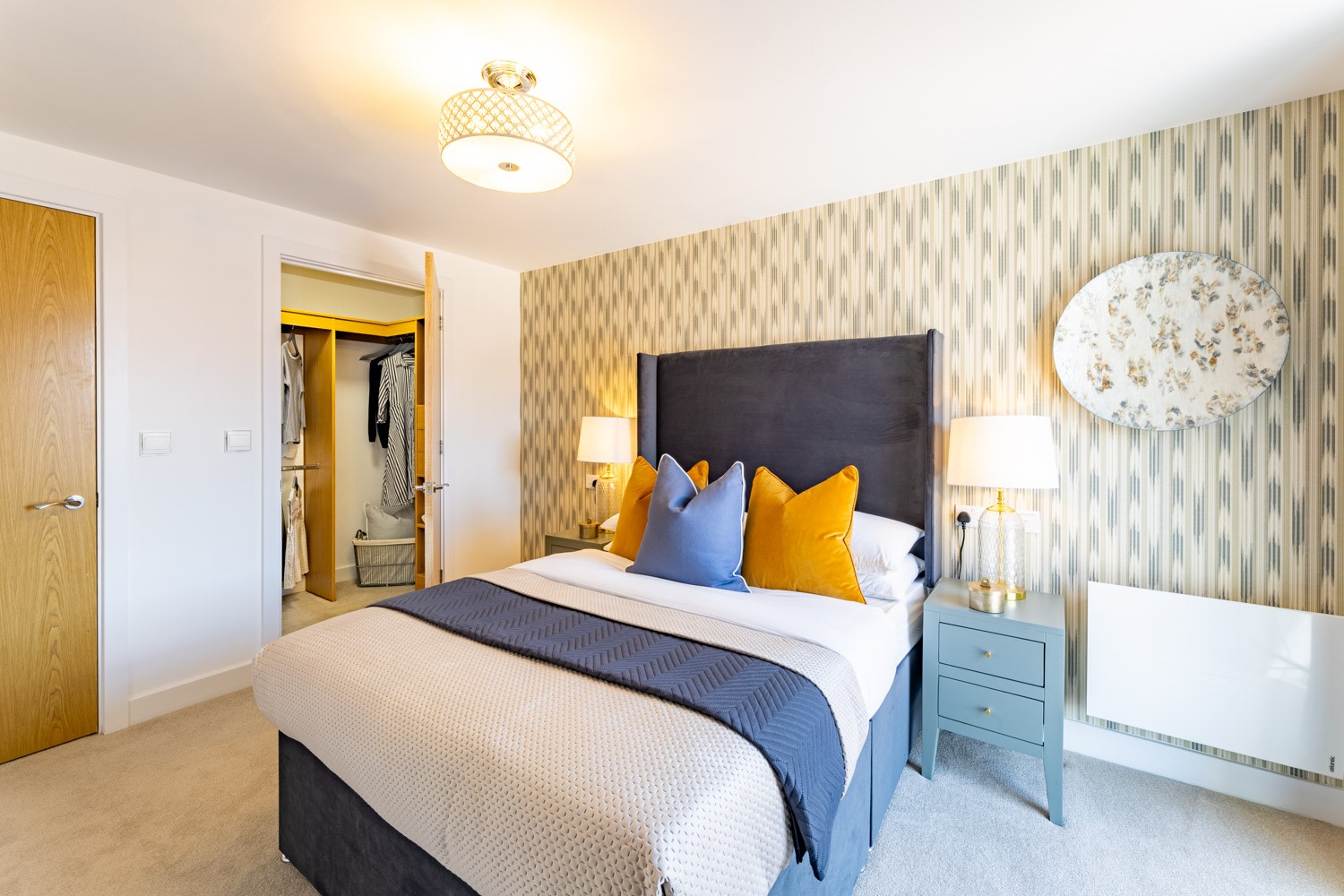 a bedroom with a bed and lamps