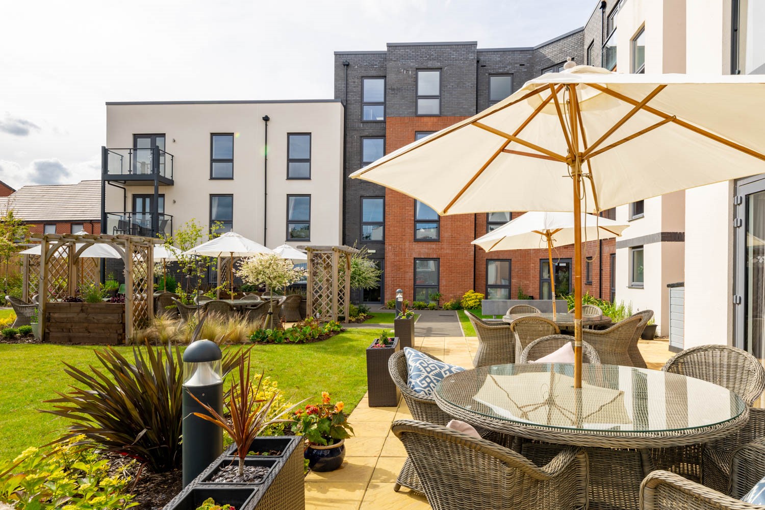 a patio with chairs and umbrellas
