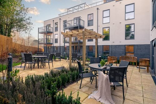 a patio with tables and chairs outside