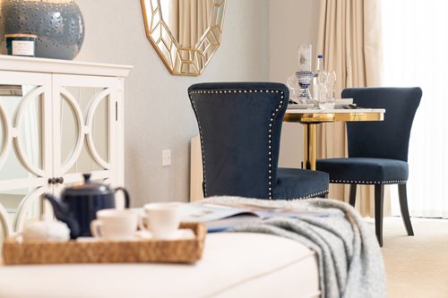a table with chairs and a mirror