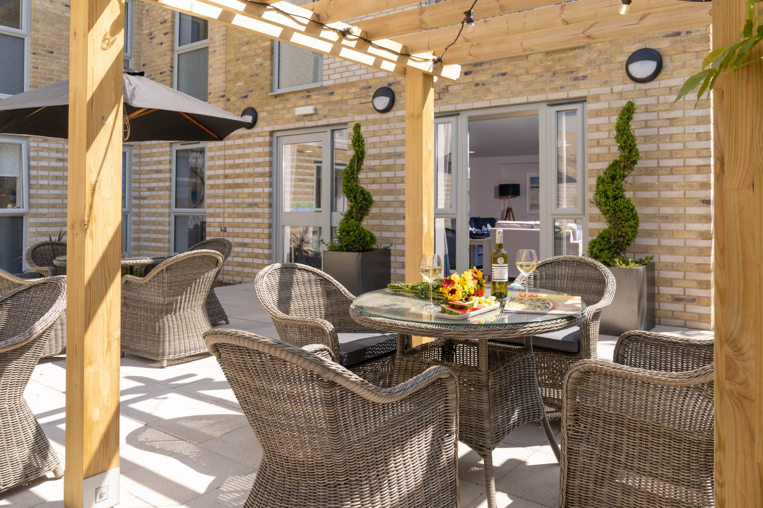 a patio with a table and chairs