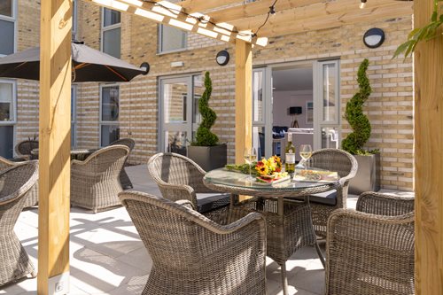 a patio with a table and chairs
