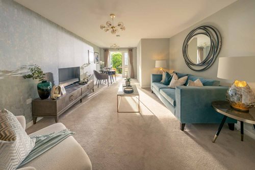 a living room with a blue couch and a round mirror