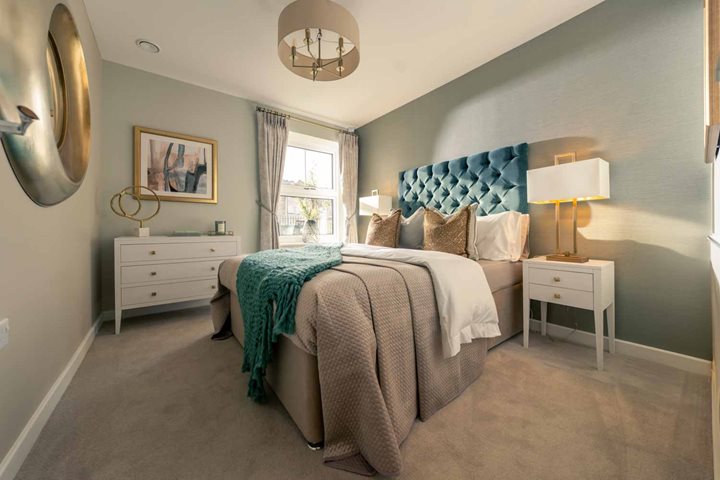 a bedroom with a bed and a lamp