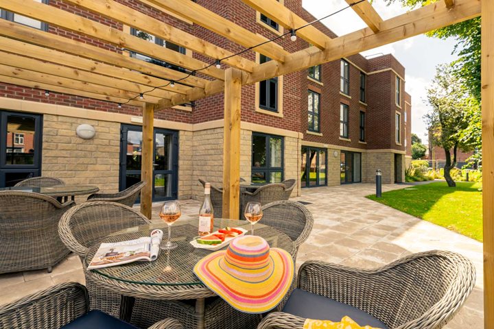 a patio with a table and chairs