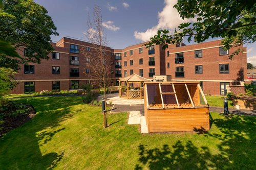 a small wooden structure in front of a brick building