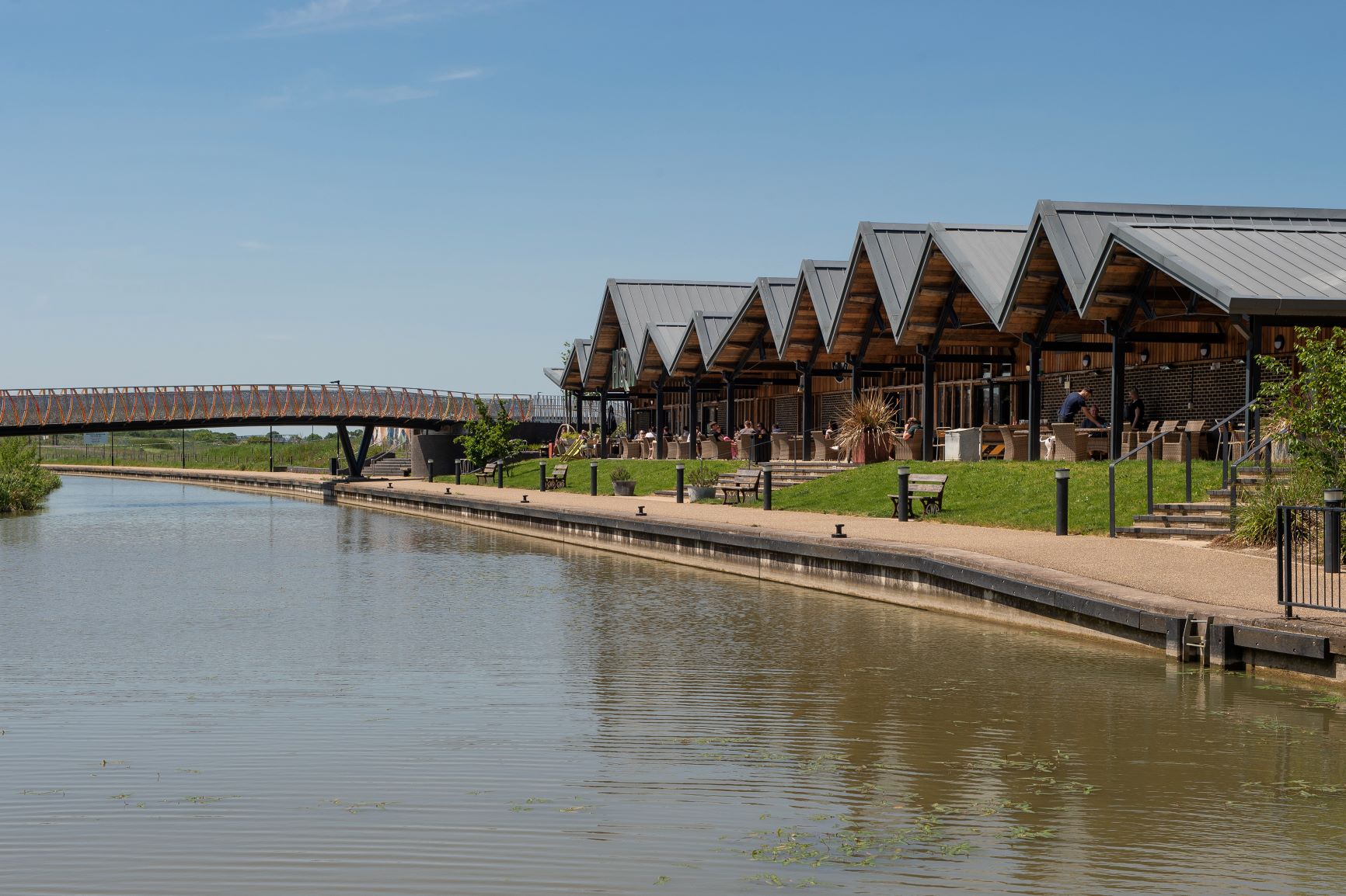 a river with a bridge and a building in the background