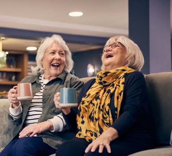 two women sitting on a couch