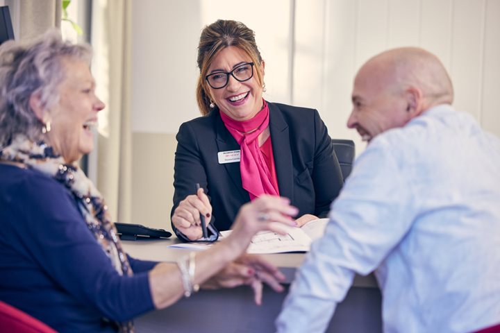 An older couple having a conversation with a sales consultant at a McCarthy Stone open day
