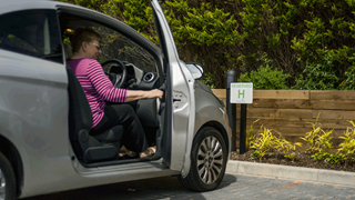 Woman getting out of car