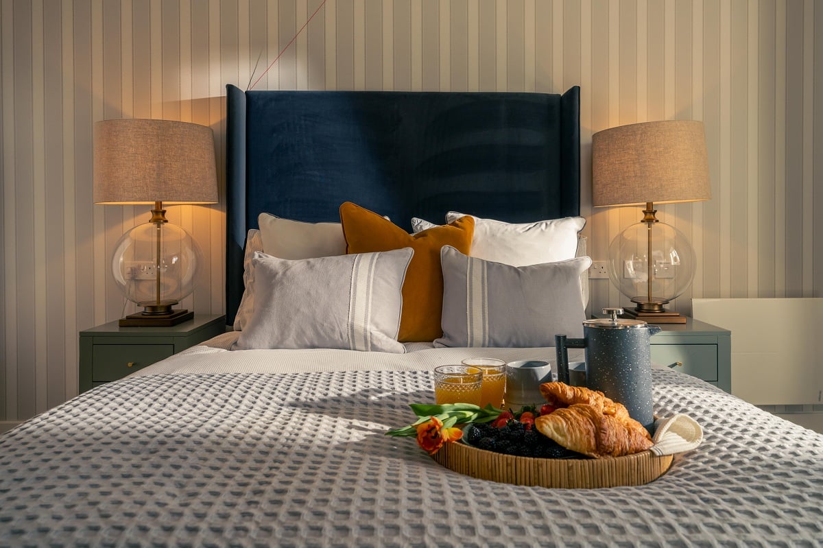 a bed with a basket of food