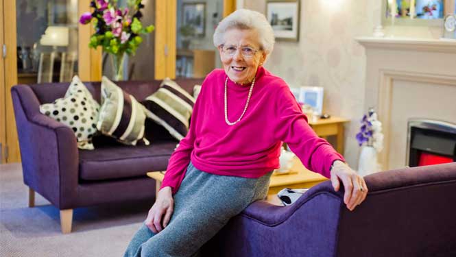an old woman sitting on a couch