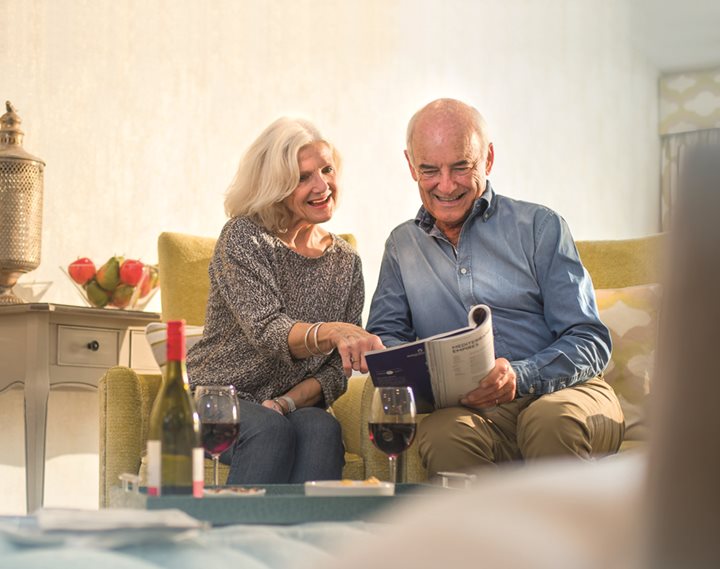 a man and a woman looking at a tablet