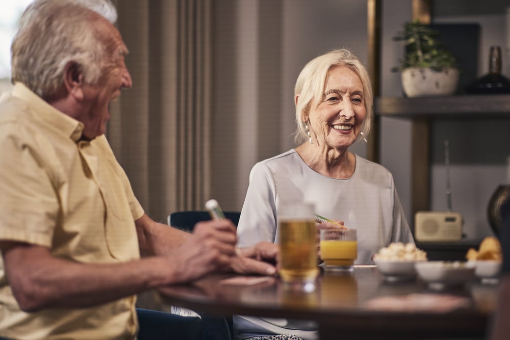 a man and a woman sitting at a table with drinks