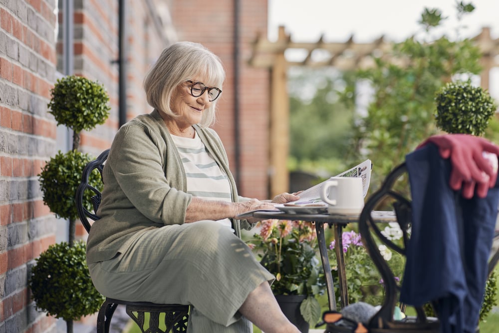 a person sitting on a bench with a laptop