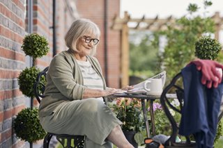 a person sitting on a bench with a laptop