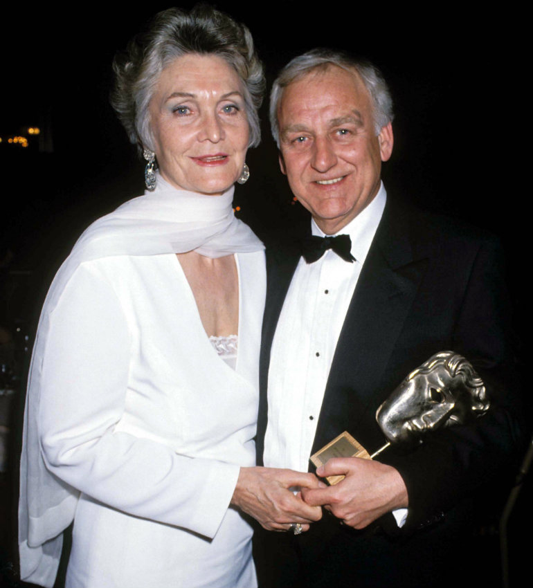 a man and woman holding awards