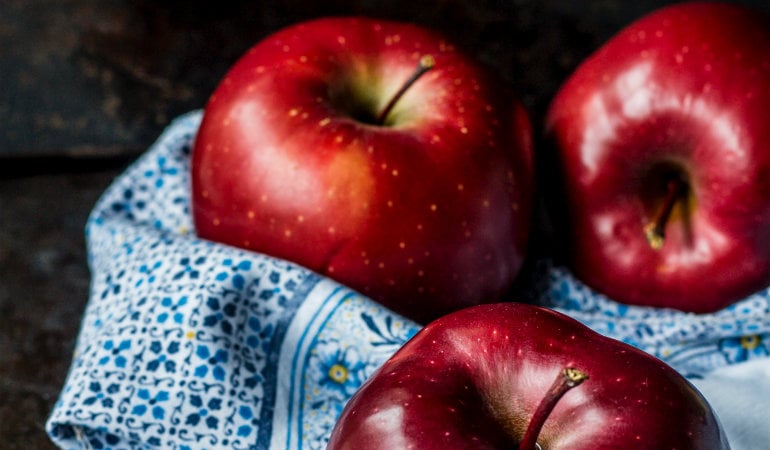 a couple of apples on a plate