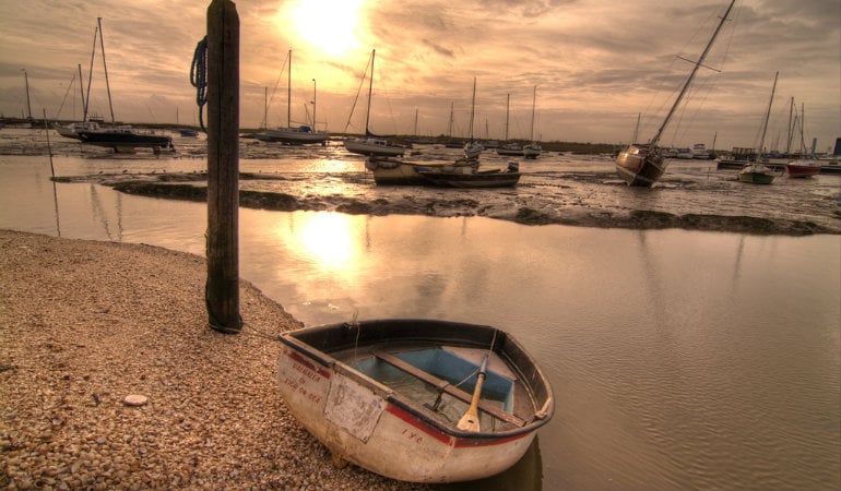 a boat is parked on the shore