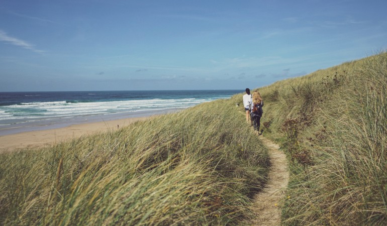 a couple walking on a beach
