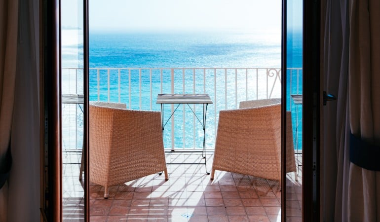 a balcony with a table and chairs