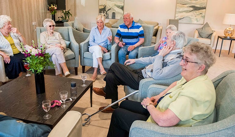 a group of people sitting in a living room
