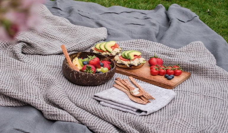 a basket of food on a blanket