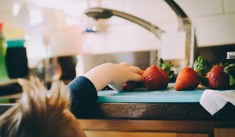 a person cutting a fruit