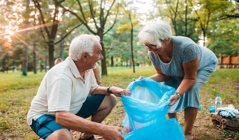 a couple of men looking at a blue bag