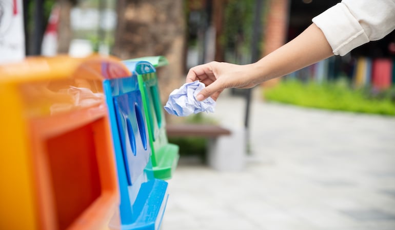 a person holding a blue shopping bag