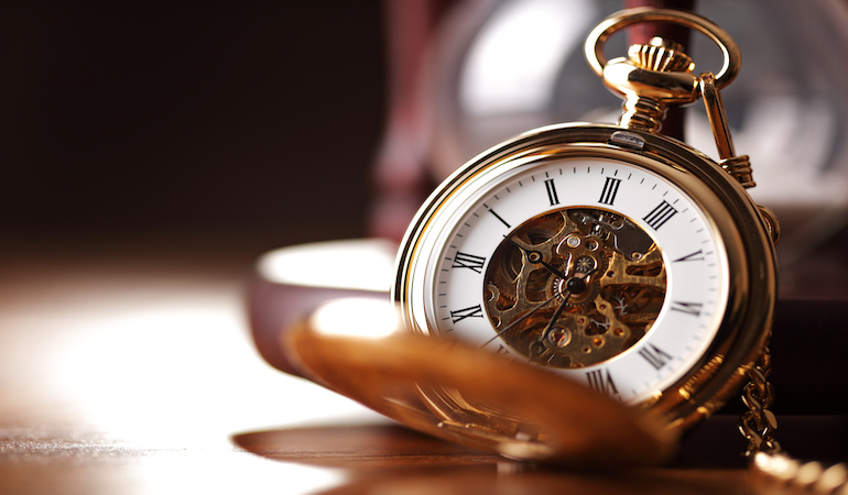 a pocket watch on a table