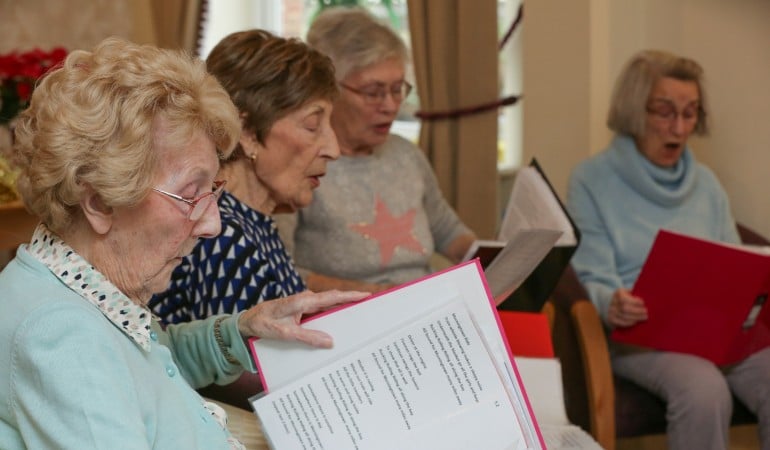a group of people sitting around a table looking at a paper