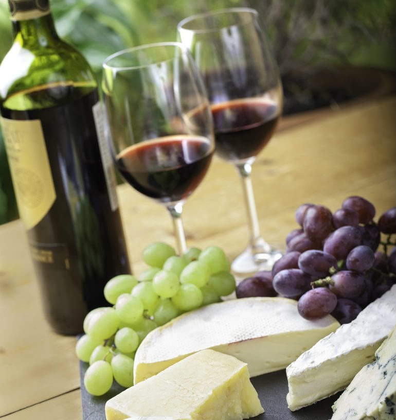 wine glasses and grapes on a table